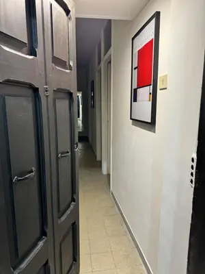 a hallway with a black door and a hallway with a hallwayngthngthngthngth at Pietra Apartment,Colosseo in Rome