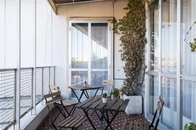a balcony with a table and chairs and a window at Savoia Luxury Penthouse in Rome