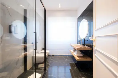 a bathroom with a toilet and a glass shower at Savoia Luxury Penthouse in Rome