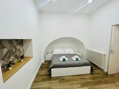 a bedroom with a bed in a white room at Boiardo Art House in Rome