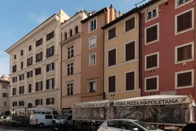 a group of buildings with cars parked in a parking lot at Historical Loft at Campo de Fiori in Rome