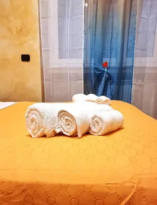 a bed with towels sitting on top of it at Wanderlust Pietralata B&B in Rome