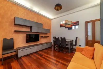 a living room with a couch and a tv and a table at GuestHost - Termini Live Laugh & Love Apartment in Rome