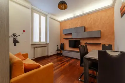 a living room with a couch and a television at GuestHost - Termini Live Laugh & Love Apartment in Rome
