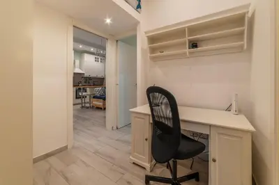 a office with a desk and a chair in a room at GuestHost - Casa Mariu' a San Pietro in Rome
