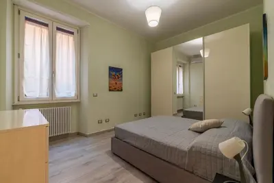 a bedroom with a bed and a large mirror at GuestHost - Casa Mariu' a San Pietro in Rome