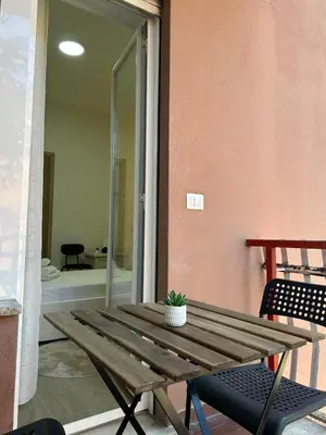 a wooden table with a potted plant on a patio at The Roman Guesthouse in Rome