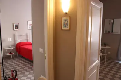 a hallway with a room with a red bed and a light at Le Stanze di Pietro in Rome