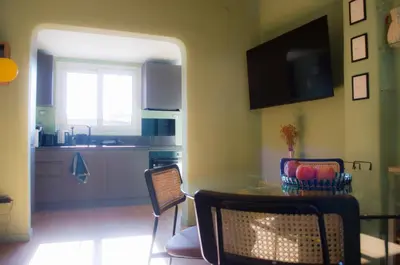 a kitchen and dining room with a table and chairs at Navona Penthouse - Attico Vista Cupola 4 posti in Rome
