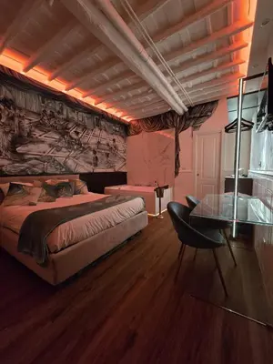 a bedroom with a bed and a glass table at Mirror Suite Roma Colosseo Monti con Jacuzzi in Rome