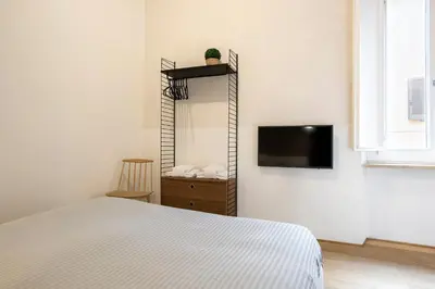 a bedroom with a bed and a tv on a wall at Cinque Loft in Rome
