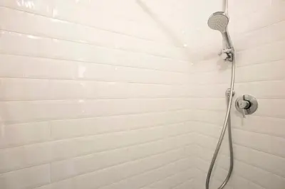a shower with a shower head in a bathroom at Cinque Loft in Rome