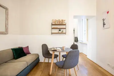 a living room with a couch and a table and chairs at Cinque Loft in Rome