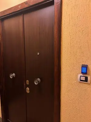 a door with a clock on the side of a wall at Casa dei fiori by GHOR in Rome