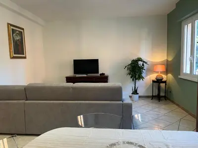 a living room with a couch and a tv at Casa dei fiori by GHOR in Rome