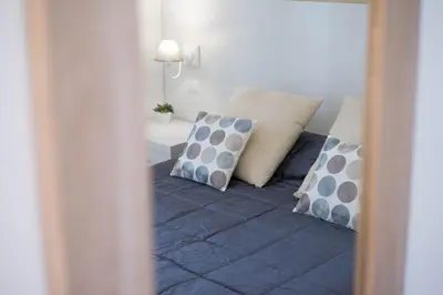 a bedroom with a bed with pillows on it at Vantaggio Suites in Rome