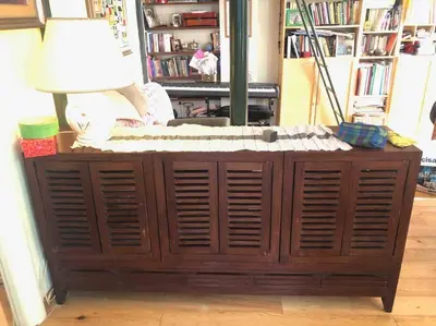 a wooden cabinet with a lamp on top of it at Centro storico appartamento con terrazza in Rome