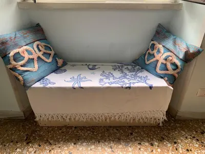 a small bed with two pillows on it at Home Carpiceci in Rome