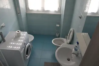 a bathroom with two toilets and a sink at Home Carpiceci in Rome
