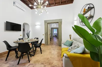a living room with a couch and a table at iFlat Magnificent flat near the Colosseum in Rome