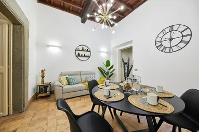 a living room with a table and chairs and a couch at iFlat Magnificent flat near the Colosseum in Rome