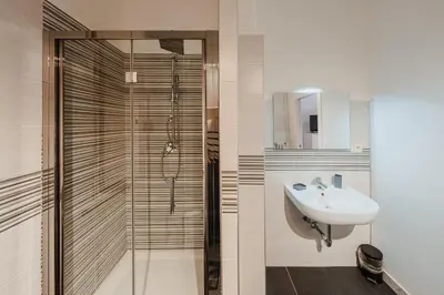 a bathroom with a sink and a shower at Be Your Home - Mazzini 144 in Rome