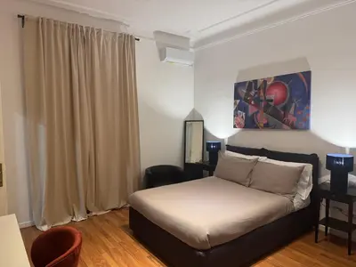 a bedroom with a bed and a painting on the wall at Be Your Home - Mazzini 144 in Rome