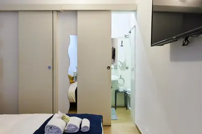 a hotel room with a bed and a television at iFlat Wonderful Home in Monti in Rome