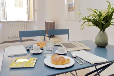 a blue table with a plate of bread on it at Cimarra Apartment in Rome