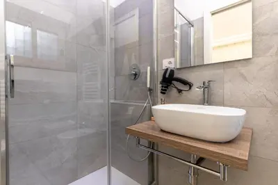 a bathroom with a sink and a shower at B&B Toto al Vaticano in Rome