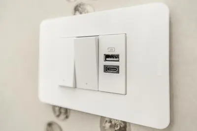 a white lightswitch on a wall at B&B Toto al Vaticano in Rome