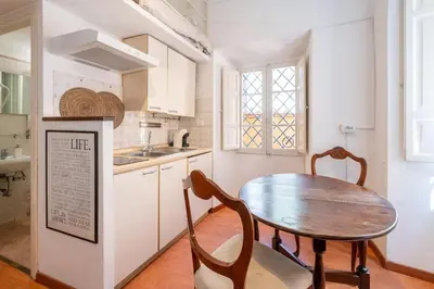 a kitchen with a wooden table and a table and chairs at Piazza Navona - Tiny House in Rome