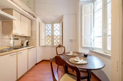 a kitchen with a table and chairs in a room at Piazza Navona - Tiny House in Rome