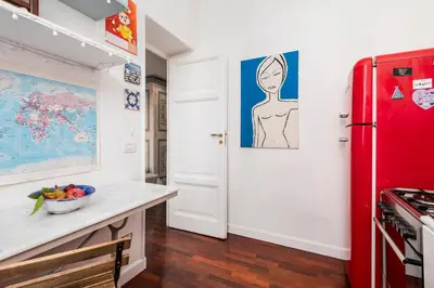 a kitchen with a red refrigerator next to a counter at Colosseum Home-ZENO 32 in Rome