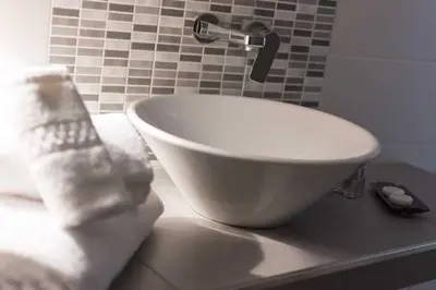 a white bowl sink on a counter in a bathroom at San Vito Suites in Rome