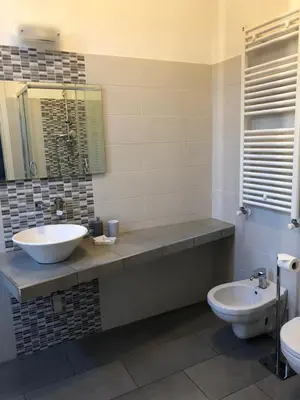 a bathroom with a sink and a toilet at San Vito Suites in Rome