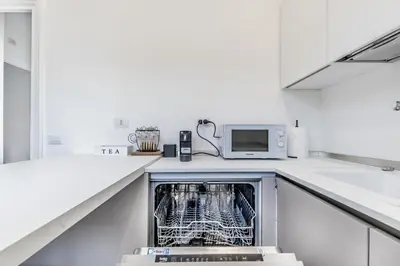 a dishwasher in a kitchen with a microwave at Vatican Central Residence in Rome