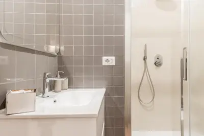 a bathroom with a sink and a shower at Vatican Central Residence in Rome