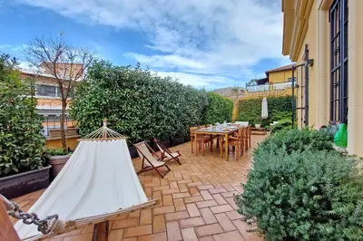 a patio with a table and chairs and a tent at LuxuryTerrace RomeApartment in Rome