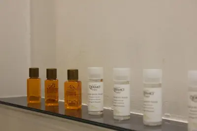 a group of four bottles of essential oils on a shelf at AD HOMES - Saint Peter Loft in Rome