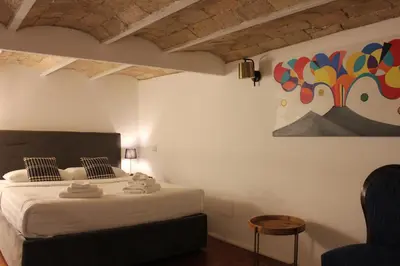 a bedroom with a bed and a painting on the wall at AD HOMES - Saint Peter Loft in Rome