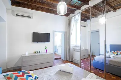 a bedroom with a bed and a tv on a wall at Suite Valeria in Rome