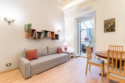 a living room with a couch and a table at Atelier dello Statuto, a few steps from Colosseo in Rome