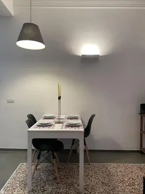 a white table with two chairs and a lamp at Cozy apartment near the Colosseum in Rome