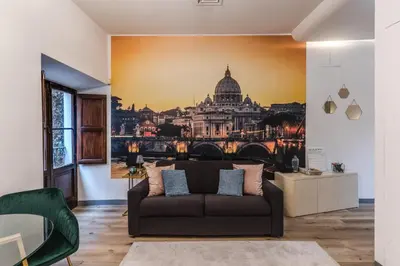 a living room with a couch and a painting of a city at Suite San Calisto Trastevere - by romanhouseit in Rome