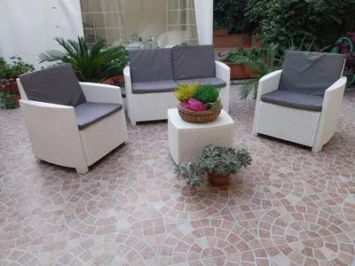 a group of chairs and plants on a patio at Il giardino di Marimar in Rome
