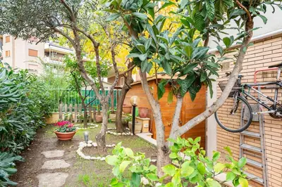 a garden with trees and a bike parked next to a building at La Casudda di Ro' - metro A Battistini in Rome