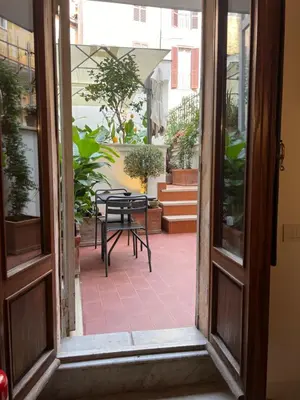 an open door to a patio with a table and chairs at Affreschi al Pantheon in Rome