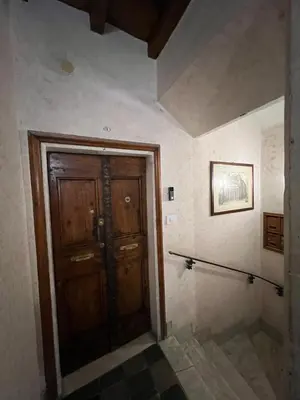 a bathroom with a wooden door in a room at Affreschi al Pantheon in Rome