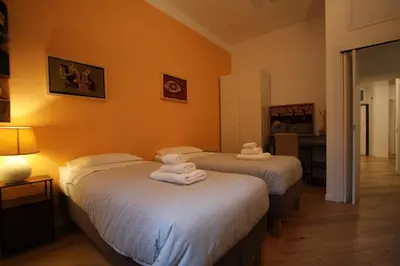 two beds in a room with towels on them at Testaccio Holiday House in Rome